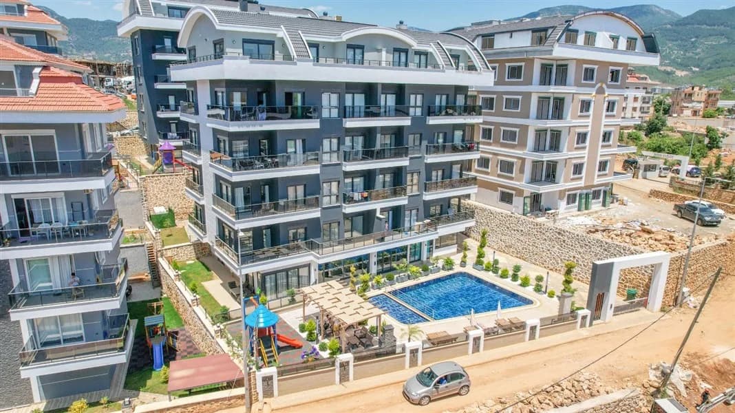 Aerial view of United Suites Oba complex with swimming pool and garden